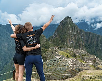 Tourist couple with a view of Machu Picchu