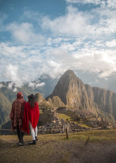 Tourist couple with view to Machu Picchu