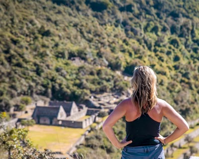 Tourist viewing the main square of the Choquequirao archaeological site.